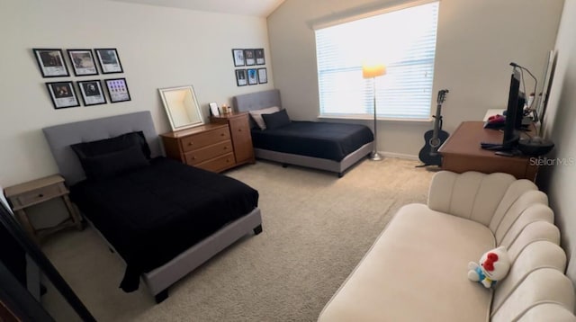 bedroom with lofted ceiling and light carpet