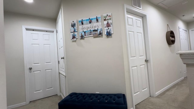 hallway featuring light colored carpet