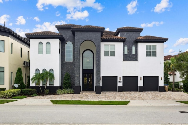 mediterranean / spanish home featuring a garage