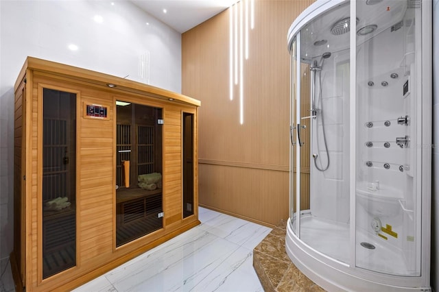 bathroom featuring a shower with door