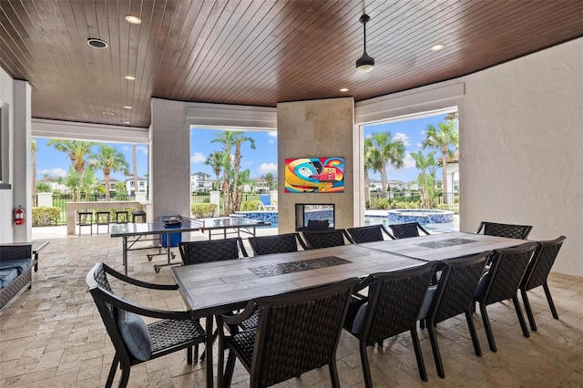 view of patio / terrace featuring an outdoor bar and a pool with hot tub