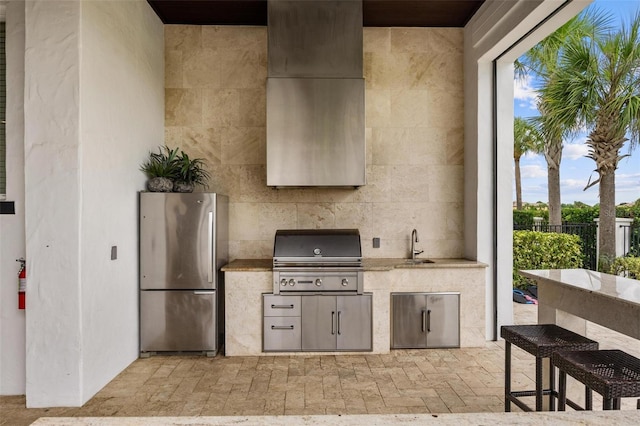 view of patio / terrace with an outdoor kitchen, area for grilling, and sink