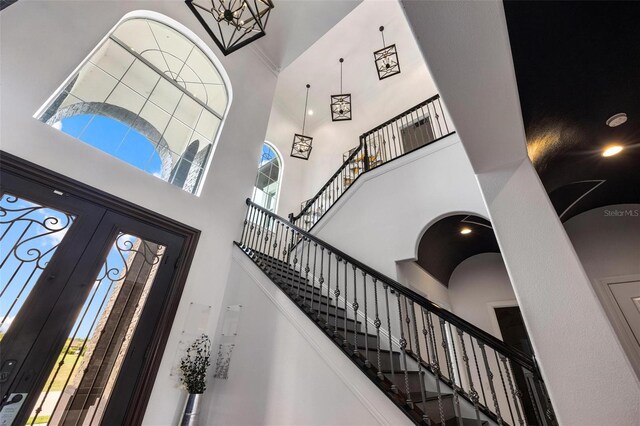 foyer entrance featuring a towering ceiling