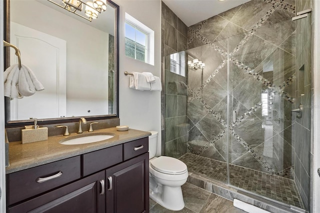 bathroom featuring tile patterned floors, vanity, toilet, and walk in shower