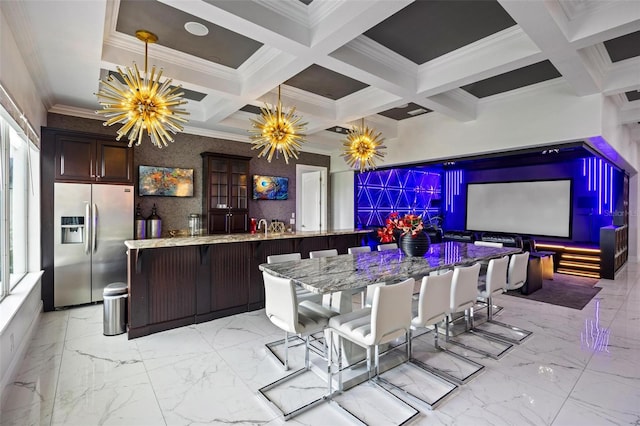 interior space with coffered ceiling, hanging light fixtures, stainless steel fridge, beamed ceiling, and a chandelier