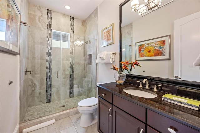 bathroom featuring vanity, toilet, plenty of natural light, and walk in shower