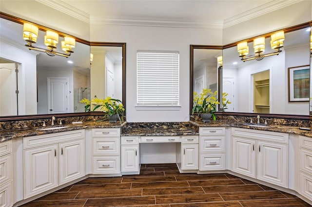 bathroom featuring hardwood / wood-style floors, ornamental molding, and an inviting chandelier