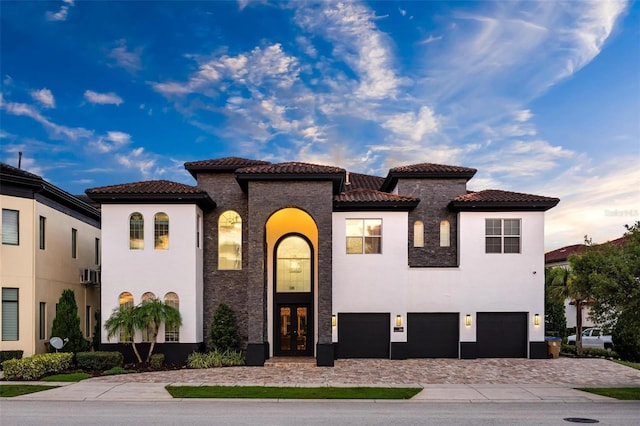 mediterranean / spanish house featuring french doors and a garage