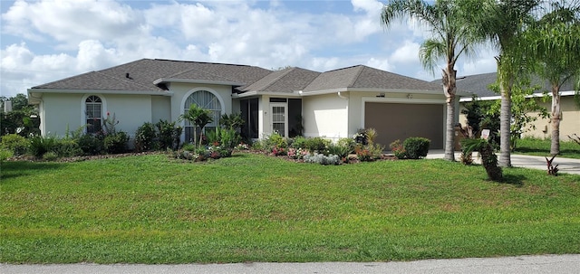 view of front of property with a garage and a front yard