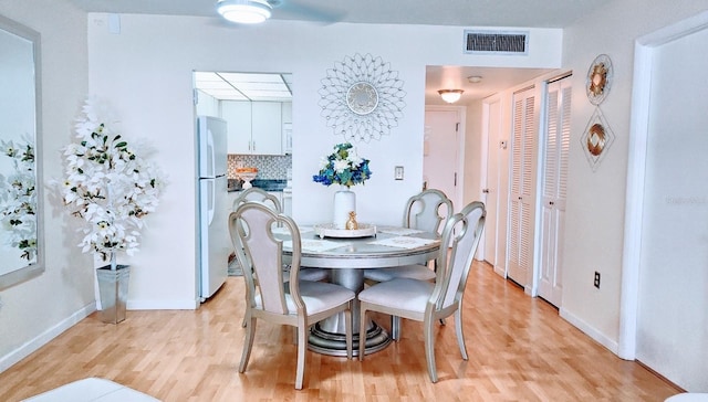 dining area with light hardwood / wood-style flooring