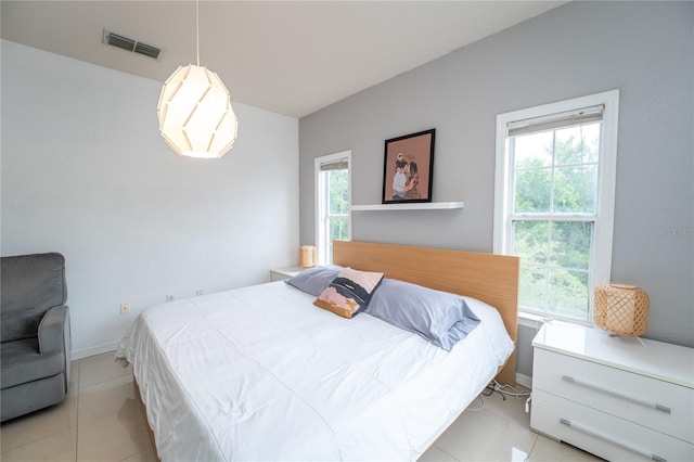 tiled bedroom with multiple windows