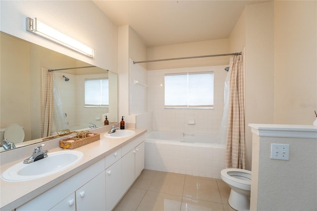 full bathroom with a healthy amount of sunlight, vanity, tile patterned floors, and toilet