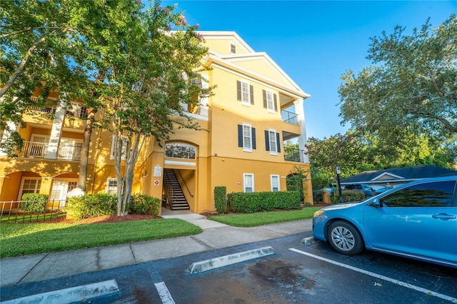 3593 Conroy Rd Unit 437, Orlando, FL 32839 - view of building exterior with uncovered parking and stairway