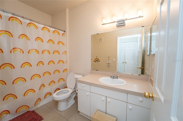 bathroom featuring vanity, toilet, and tile patterned flooring