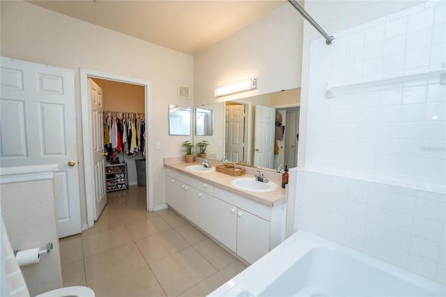 bathroom with tile patterned flooring, vanity, and a tub