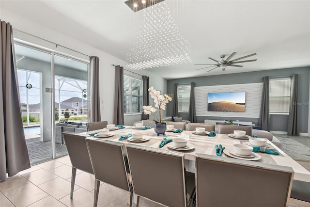 dining space with light tile patterned floors and ceiling fan with notable chandelier