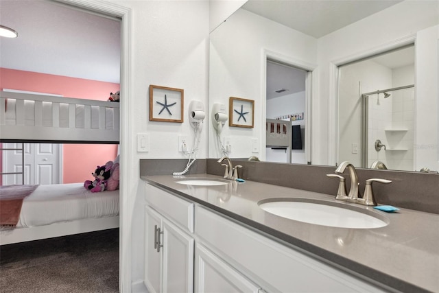 bathroom with a shower with door and vanity