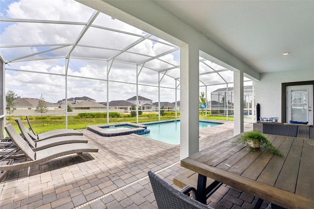 view of pool with an in ground hot tub, a lanai, and a patio area