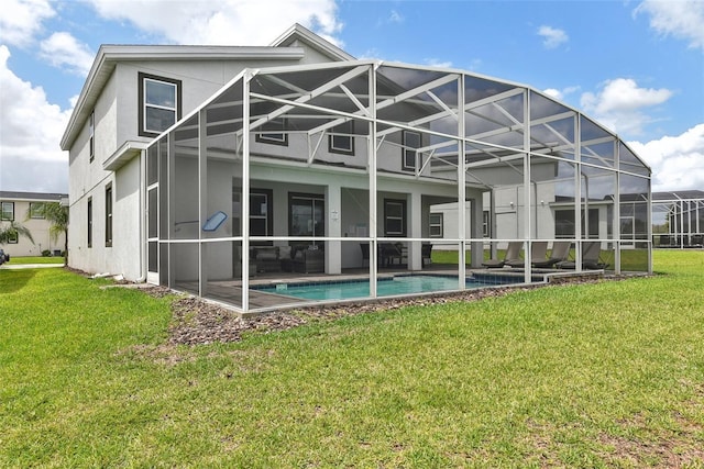 rear view of house featuring a lanai and a lawn