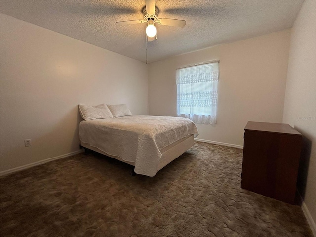 bedroom with dark carpet, a textured ceiling, and ceiling fan