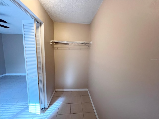 spacious closet featuring light tile patterned flooring