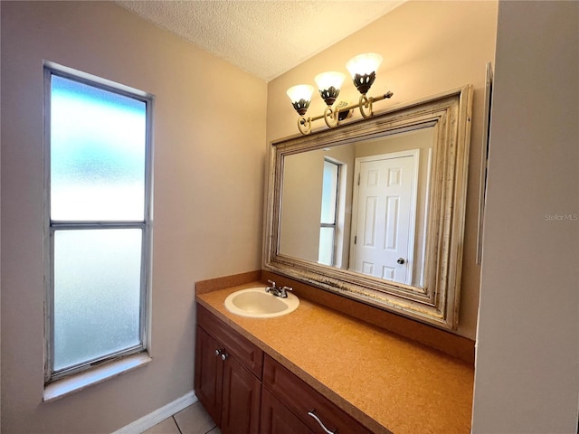 bathroom featuring vanity, a textured ceiling, and tile patterned flooring