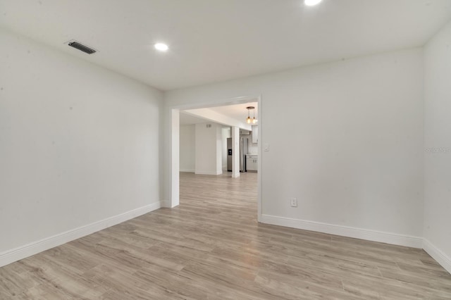 unfurnished room with light hardwood / wood-style flooring