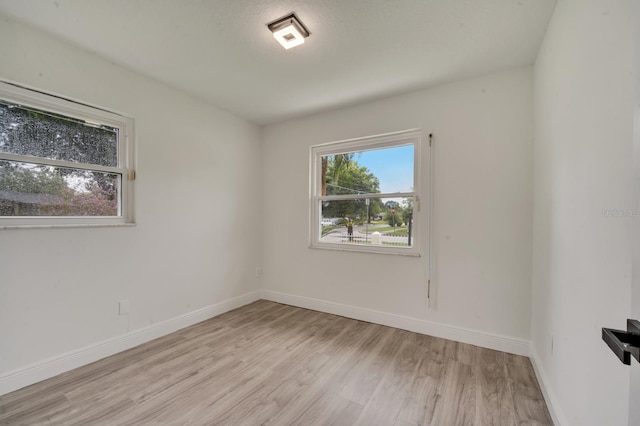 unfurnished room featuring light hardwood / wood-style floors