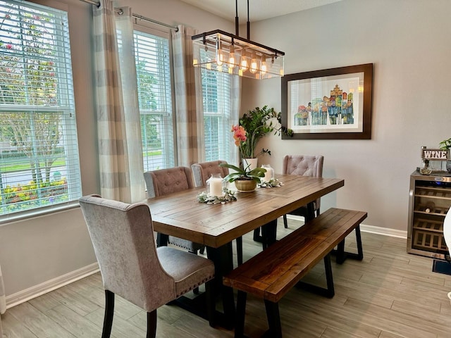 dining room featuring a wealth of natural light, light hardwood / wood-style flooring, and an inviting chandelier