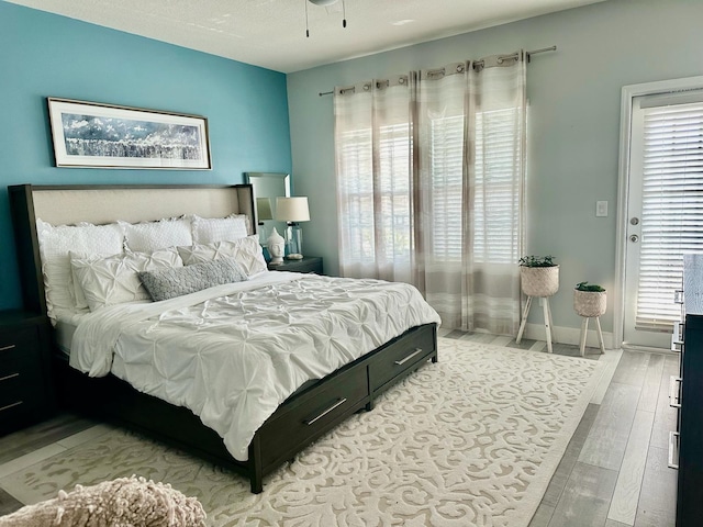 bedroom featuring hardwood / wood-style flooring and a textured ceiling