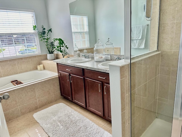 bathroom featuring tile patterned flooring, vanity, and shower with separate bathtub