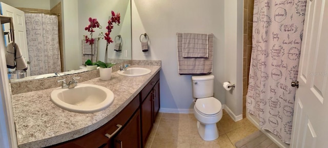 bathroom with vanity, toilet, a shower with curtain, and tile patterned floors