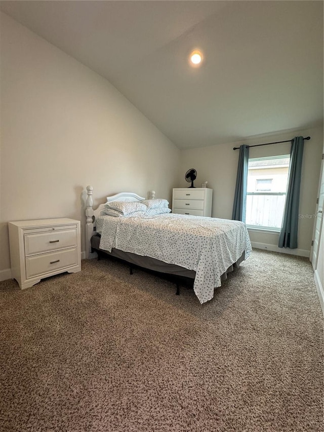 bedroom featuring vaulted ceiling and carpet