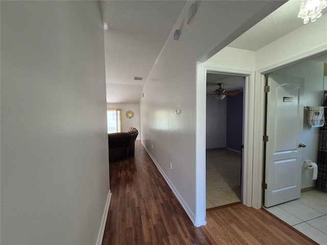 corridor with hardwood / wood-style flooring