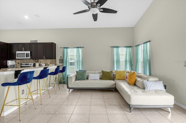 living room featuring ceiling fan and light tile patterned floors