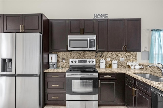 kitchen with dark brown cabinetry, light stone countertops, sink, and stainless steel appliances