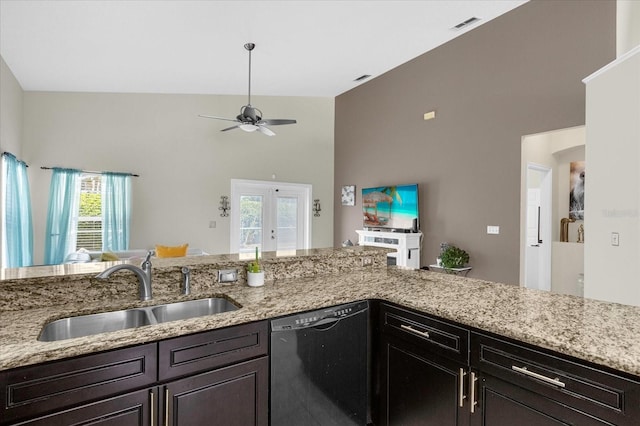 kitchen with dishwasher, light stone counters, sink, and french doors