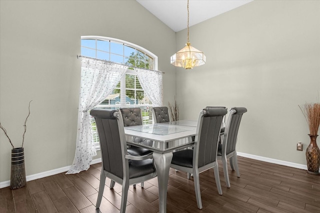 dining space featuring a chandelier, dark hardwood / wood-style floors, and vaulted ceiling