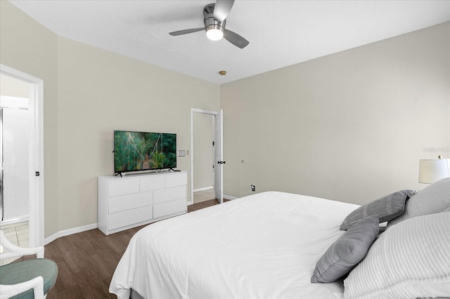 bedroom with ensuite bath, ceiling fan, and hardwood / wood-style flooring