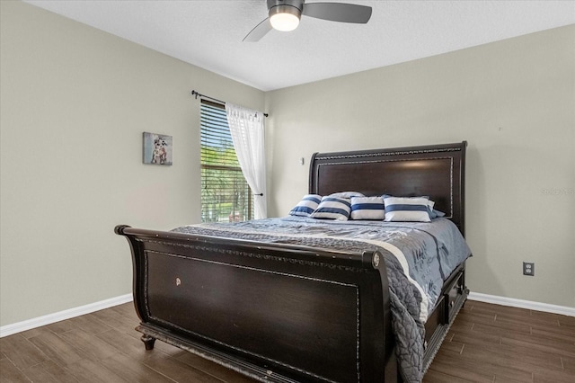 bedroom with ceiling fan and dark wood-type flooring