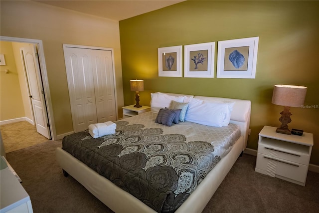 bedroom featuring a closet and dark colored carpet