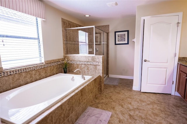 bathroom with separate shower and tub, tile patterned floors, and vanity