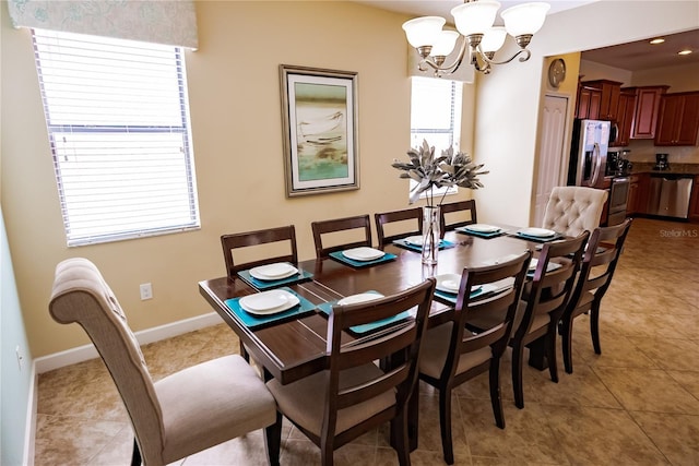 dining space with light tile patterned floors and a notable chandelier