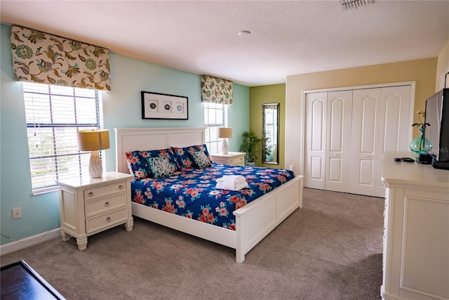 bedroom featuring light colored carpet and a closet