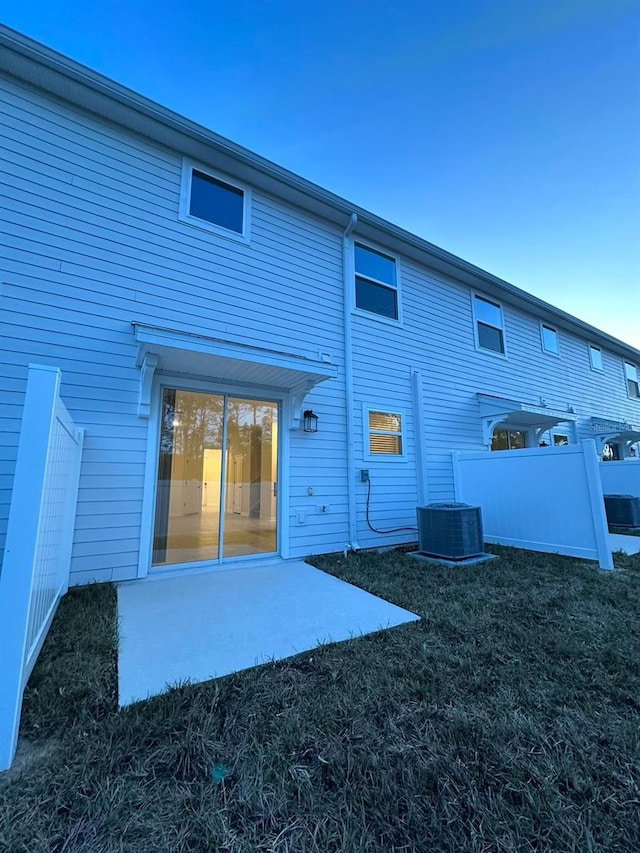 rear view of house with central air condition unit