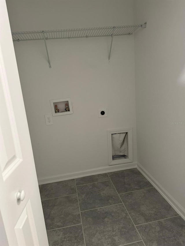 laundry room with hookup for an electric dryer, washer hookup, and dark tile patterned flooring