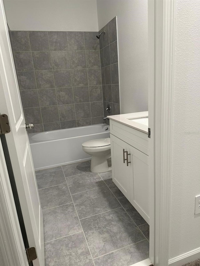 full bathroom featuring toilet, vanity, and tiled shower / bath