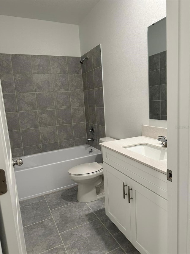 full bathroom featuring vanity, toilet, and tiled shower / bath