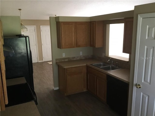 kitchen with sink, pendant lighting, dark hardwood / wood-style floors, and black appliances