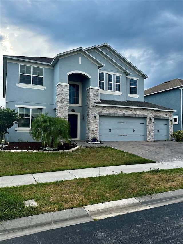 view of front of home with a garage and a front lawn